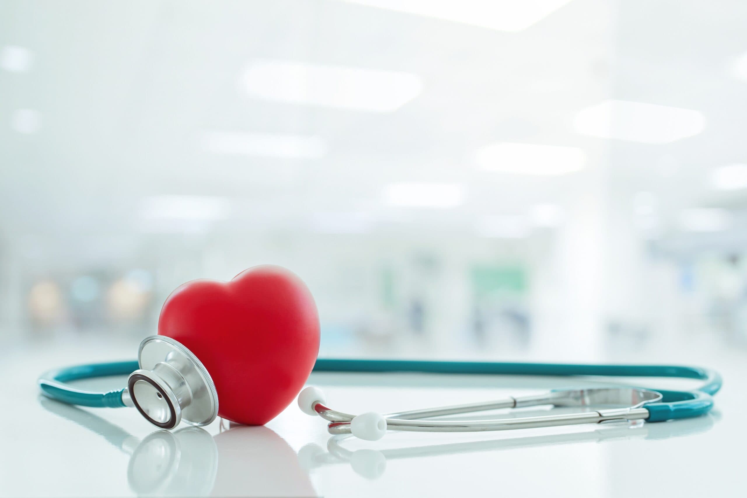 Doctor holding a red heart-shaped exercise ball