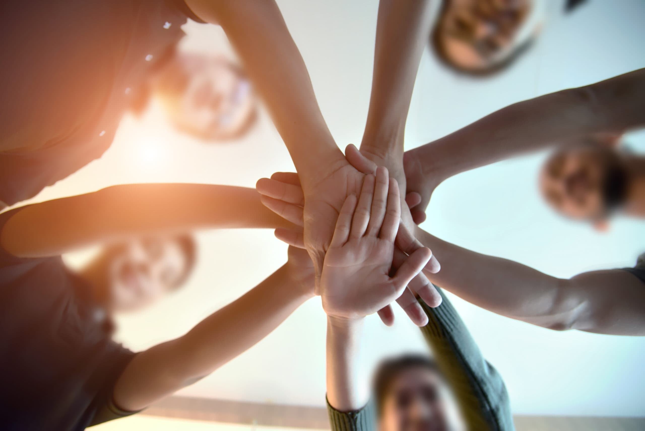 A group joining hands in support
