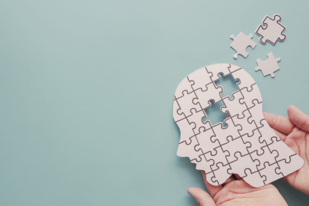 Puzzle pieces forming a human head, representing healing and processing