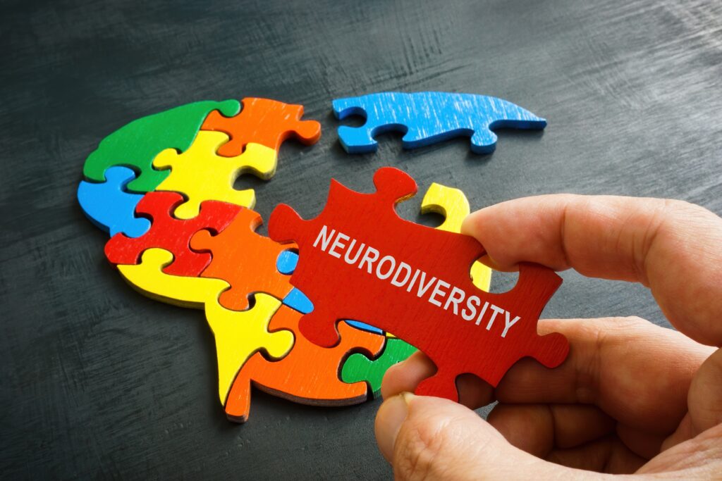 neurodiversity,concept.,brain,from,puzzle,and,a,hand,holds,a